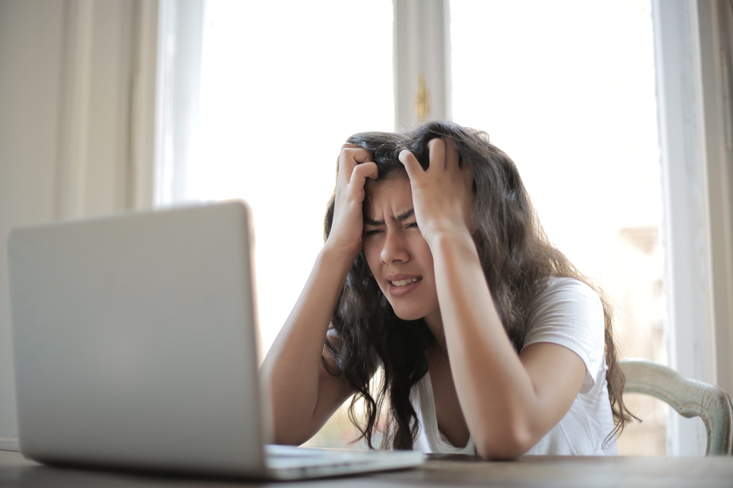 Frustrated woman in front of her computer.